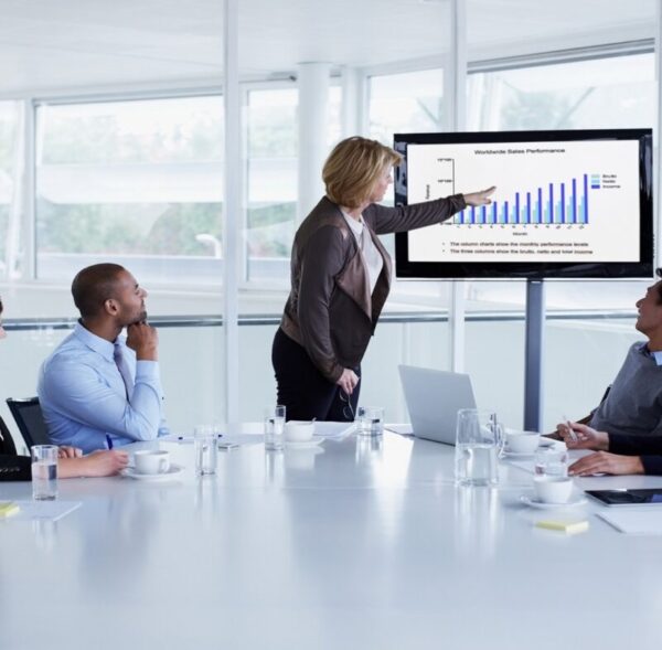 Businesswoman giving presentation to colleagues in conference meeting